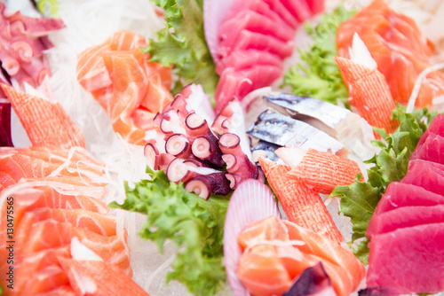 Sashimi on iced glass dish, japanese food, Fresh catch of fish and other seafood close-up..