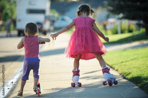 Children riding on sidewalk
