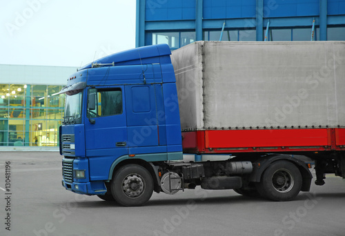 Truck on car parking near warehouse. Delivery and shipping concept.
