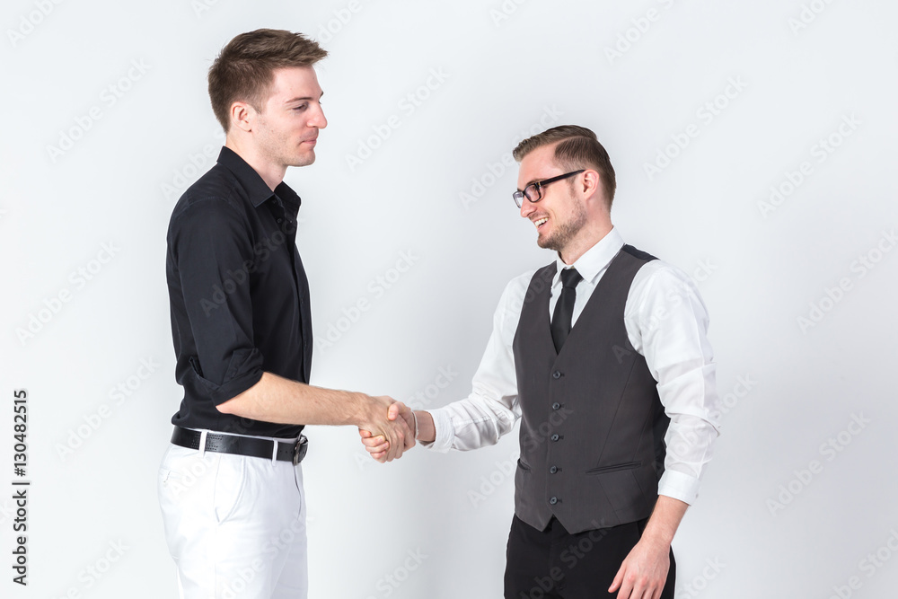 Portrait of two businessmen shaking hands business dealing succe