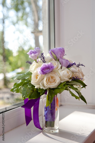 букет из белых роз и фиолетовых цветов стоит у окна