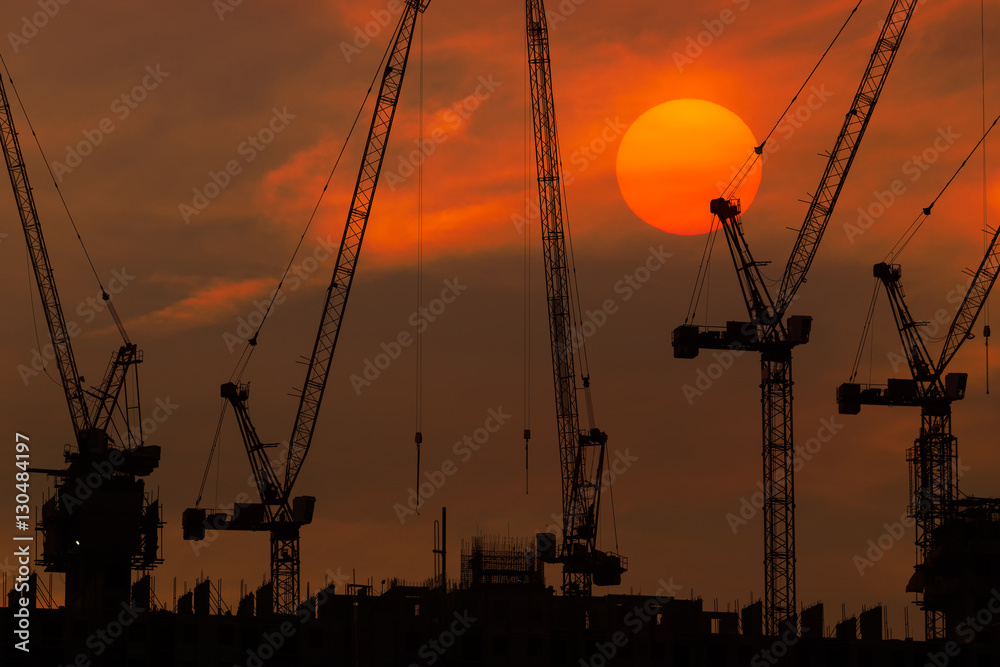 sunset and silhouette of the crane operating