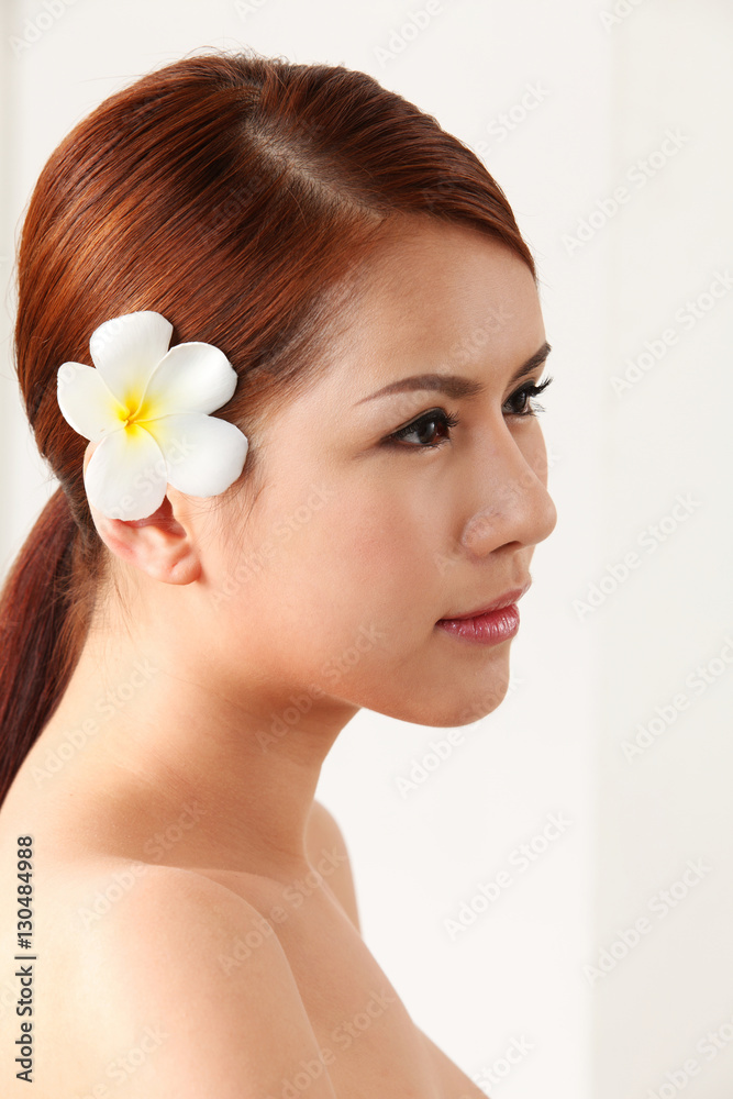 Fototapeta premium frangipani in her ear
