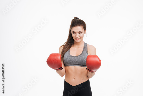Portrait of a young surprised fitness woman wearing boxing gloves © Drobot Dean