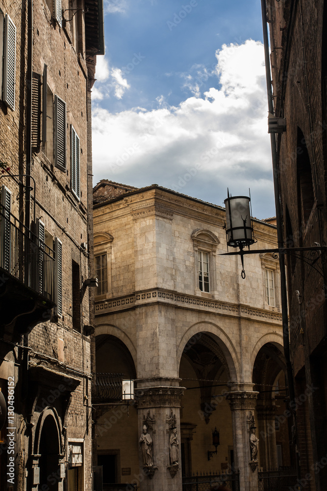 narrow street and old houses in Siena