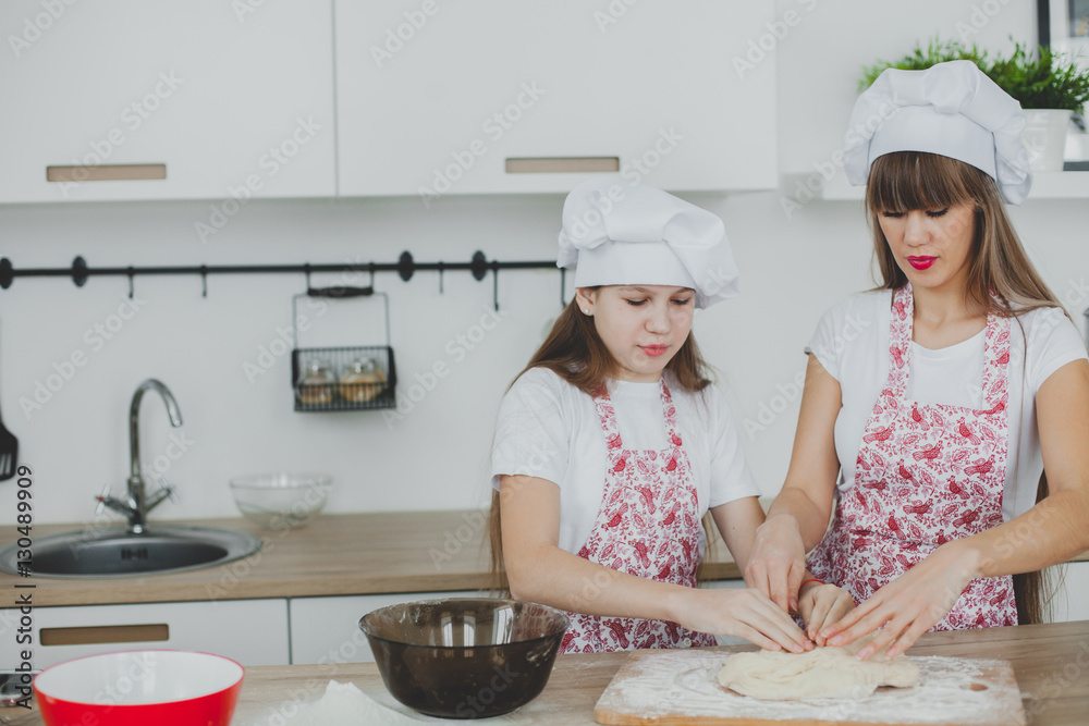 Mother with her daughter are preparing the buns Mother with her daughter are preparing the buns