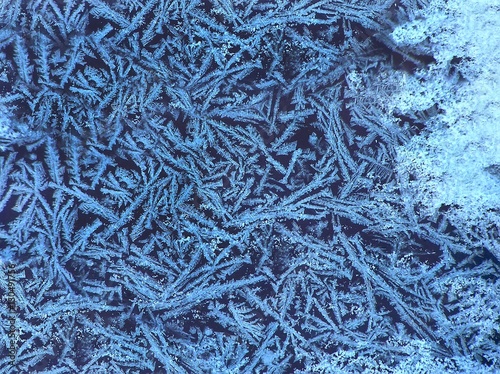 Beautiful natural frosty pattern on winter window. Selective focus
