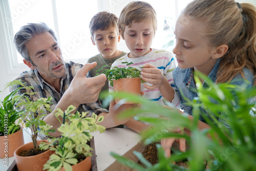 Teacher with kids in biology class learning about plants photo