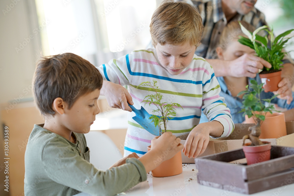 Teacher with kids in biology class learning about plants Teacher with kids in biology class learning about plants