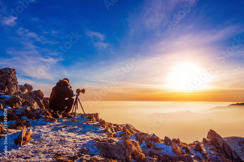 Professional photographer takes photos with camera on tripod on Deogyusan mountain.