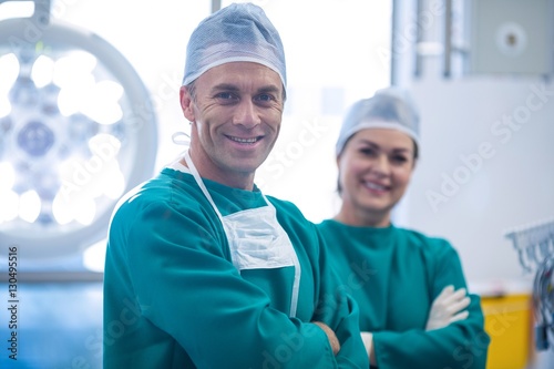 Portrait of surgeons standing with arms crossed 