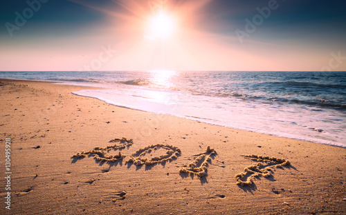 Year 2017 written at the sand