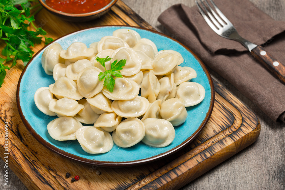 Ravioli with red sauce on the wooden table Ravioli with red sauce on the wooden table