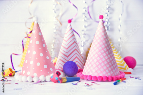 Birthday party caps on wooden background