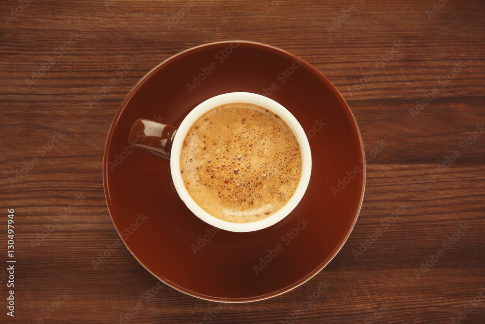 Obraz premium Cup of coffee on wooden background
