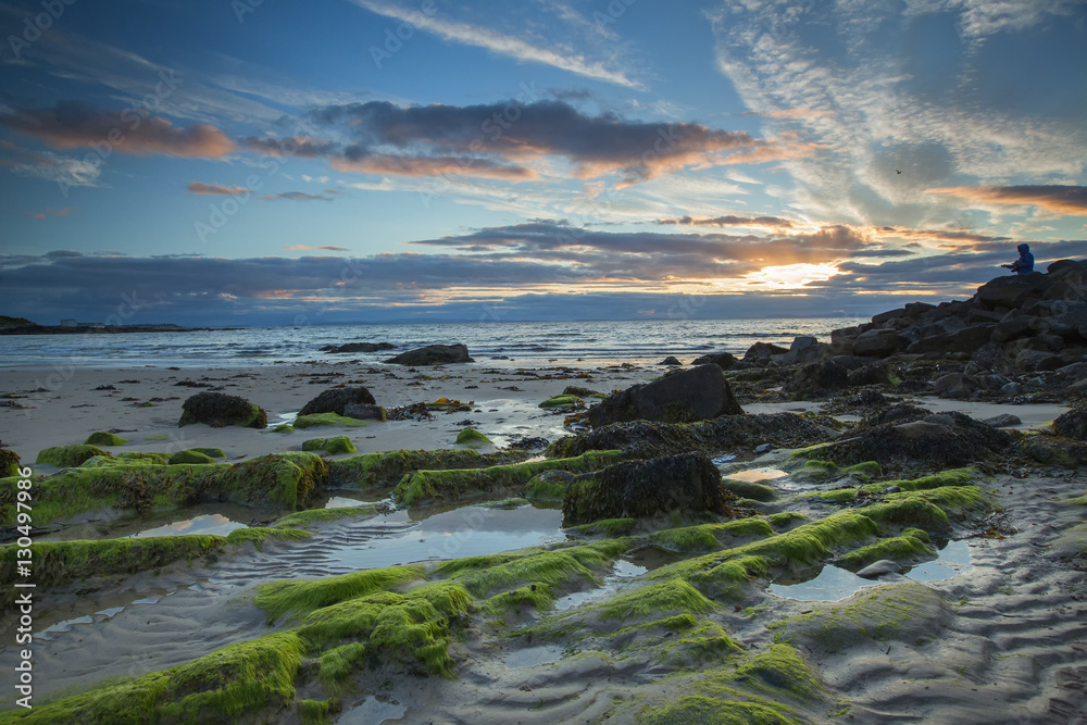 Sunset over Scottish sea with stones