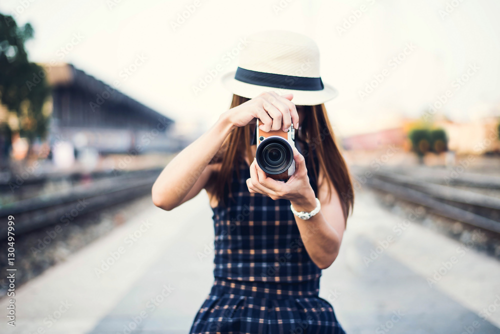 The hipster woman take a photo for travel on the street