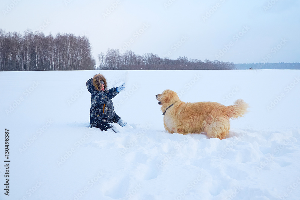 child plays with dog in winter