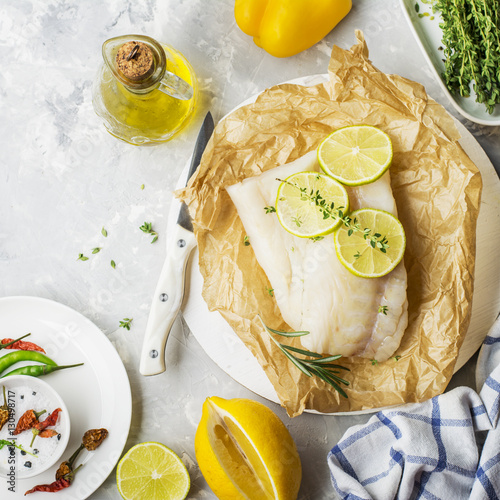 Cod fillets with vegetables before cooking in parchment paper photo