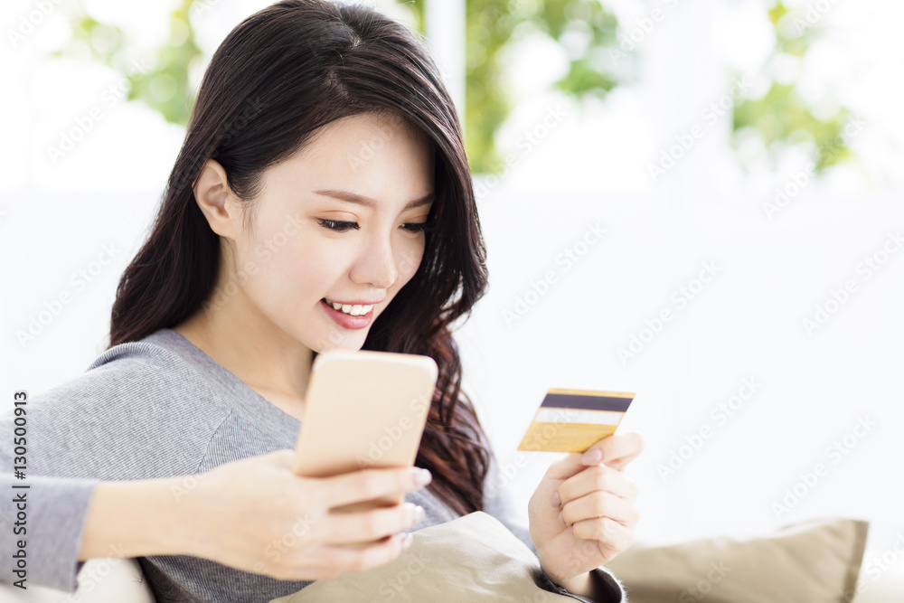 young beautiful woman with credit card and smart phone young beautiful woman with credit card and smart phone