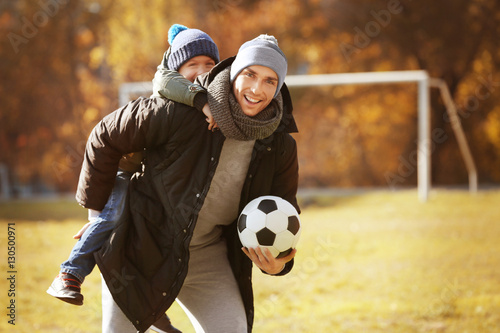 Father and son with ball on...