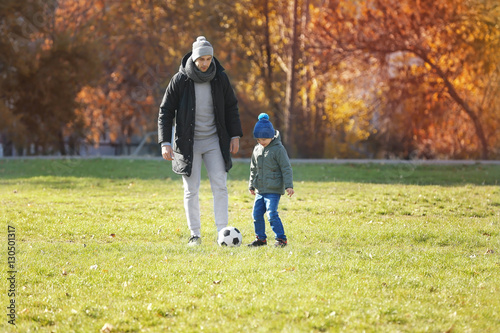 Father and son playing foot...