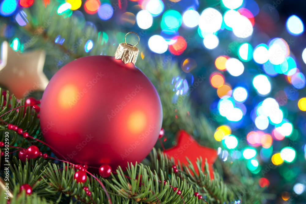 Christmas ball and spruce branch on abstract background
