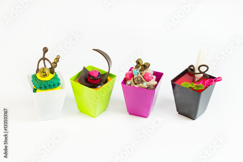 Mini desserts and meat canapes vegetable snacks in plastic cups canaps