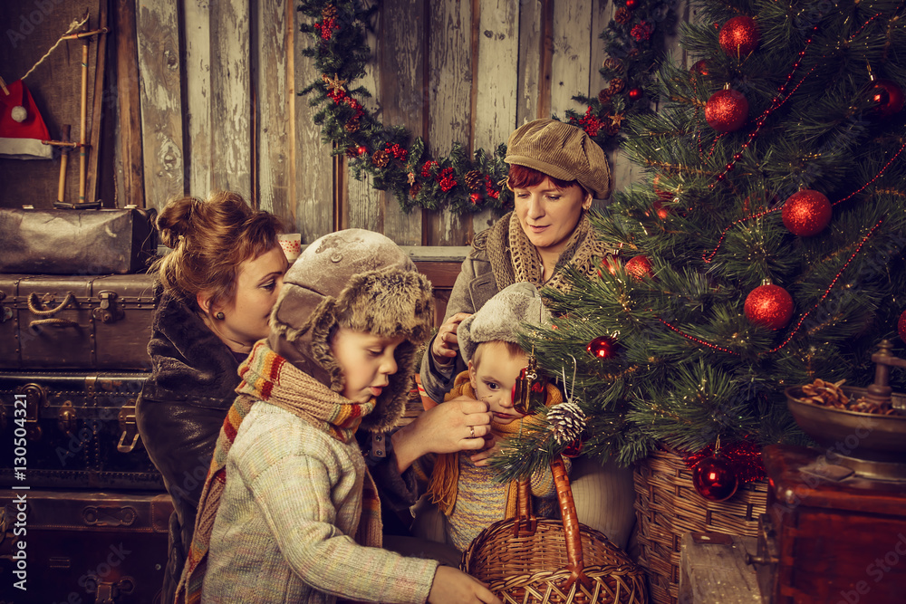 Mothers with children decorate the Christmas tree.