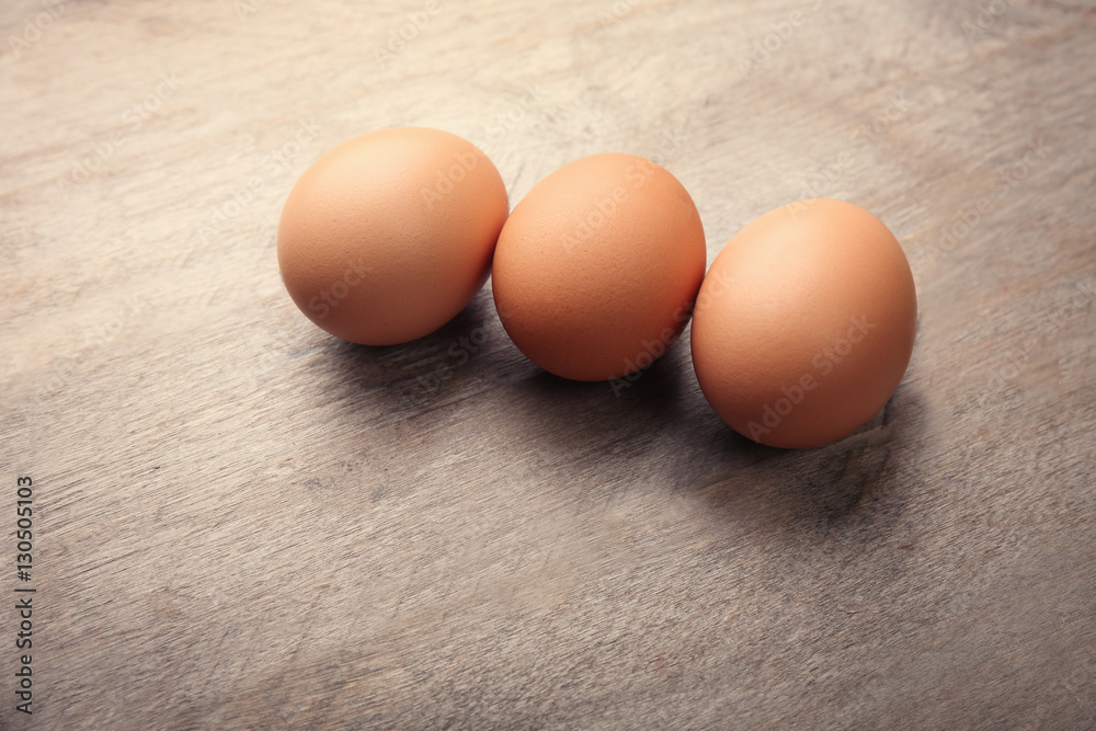 Raw eggs on wooden background Raw eggs on wooden background