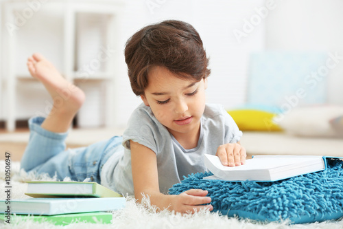Cute little boy lying on th...