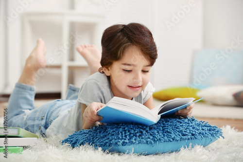 Cute little boy lying on th...
