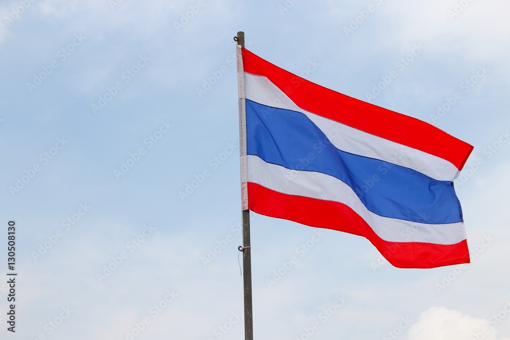 Thai flag, waving in the wind with beautiful with blue sky background Thai flag, waving in the wind with beautiful with blue sky background