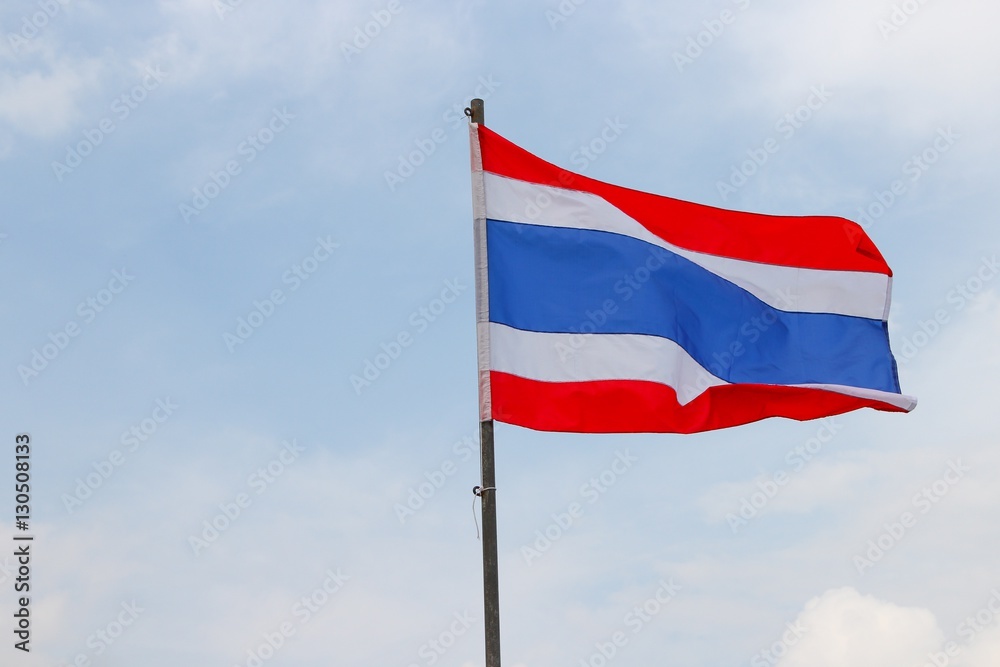 Thai flag, waving in the wind with beautiful with blue sky background Thai flag, waving in the wind with beautiful with blue sky background