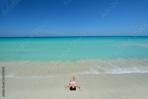 Young beautiful girl on the beach photo