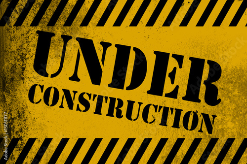 Under construction sign yellow with stripes