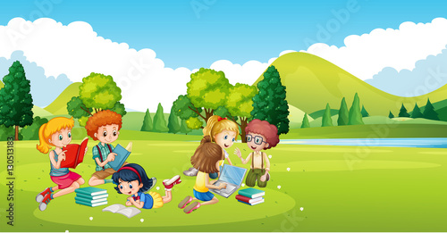 Children working and reading book in the park