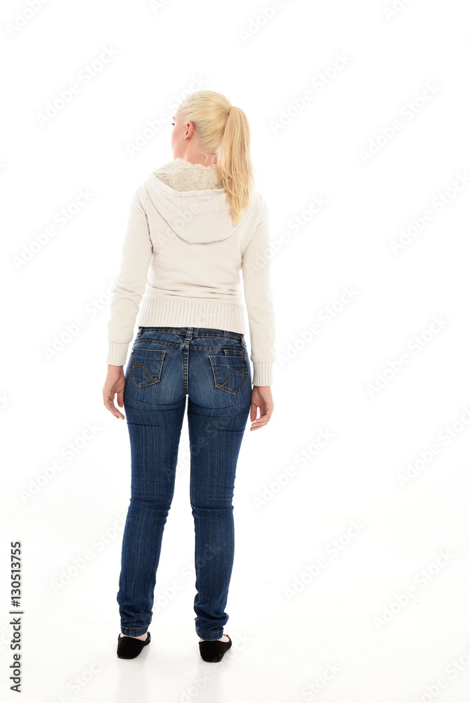 Full length portrait of a pretty girl wearing a casual white hoody and blue jeans. standing pose isolated against a white background. Full length portrait of a pretty girl wearing a casual white hoody and blue jeans. standing pose isolated against a white background.