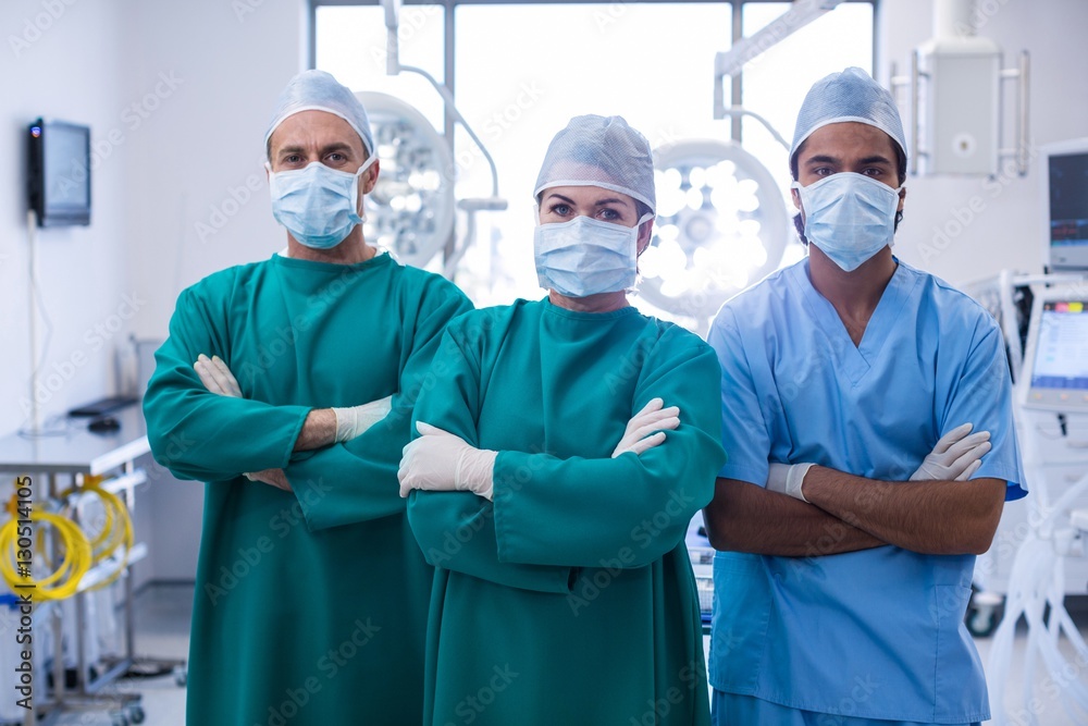 Portrait of surgeons standing with arms crossed Portrait of surgeons standing with arms crossed