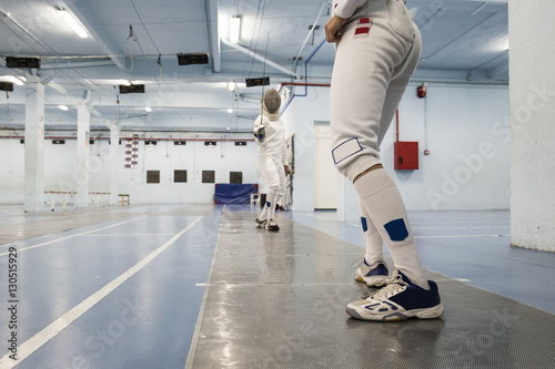 Female fencers during a fencing match photo