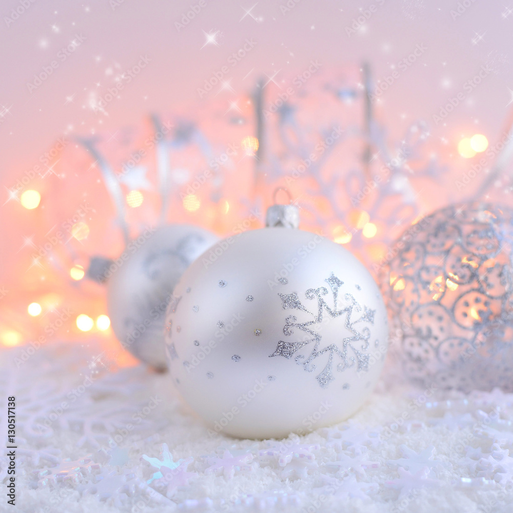 Christmas decorative balls on snow and Christmas lights. Festive Christmas background