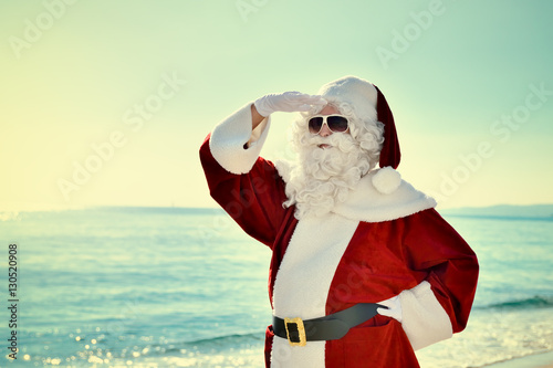 Christmas Vacation - Santa standing on the beach, looking for …