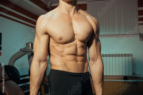 Naked male body in the gym