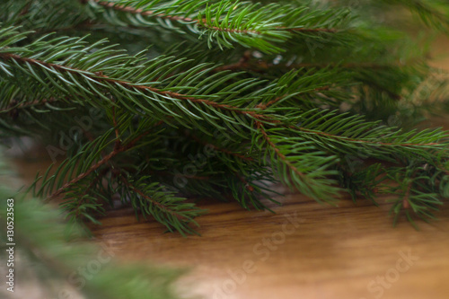 Christmas-tree branch and berries on a wooden background