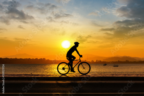 Man cycling at beach evening time