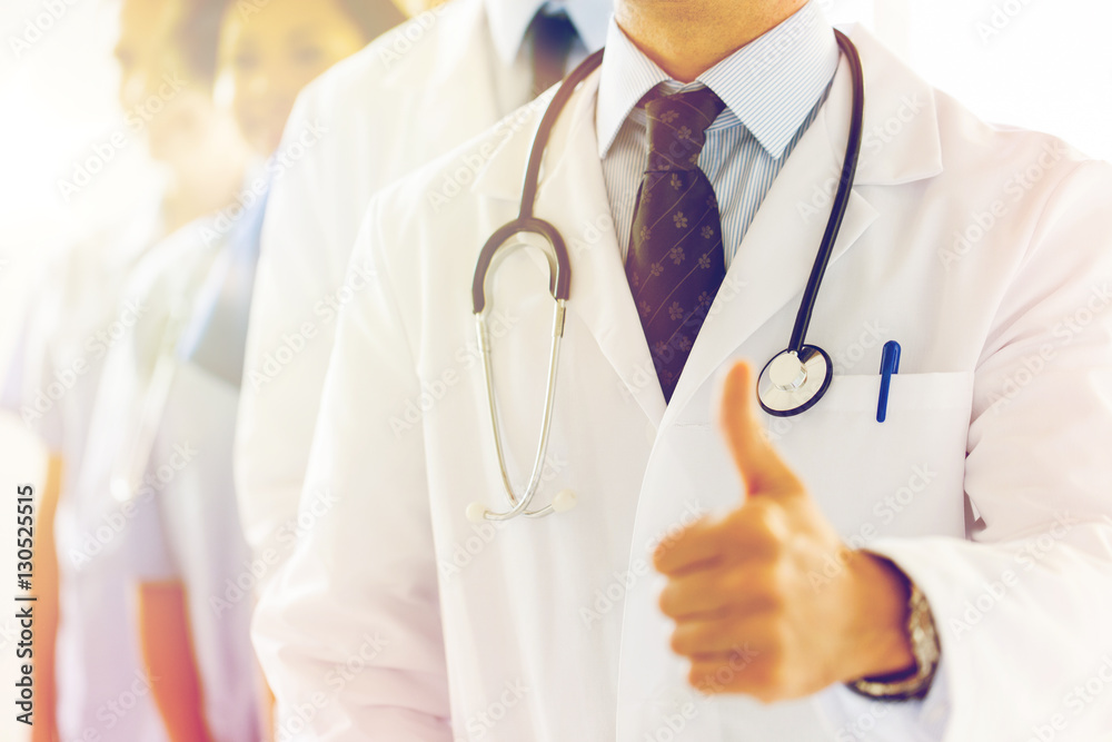 close up of happy doctor showing thumbs close up of happy doctor showing thumbs