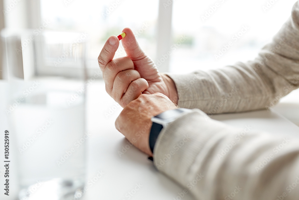 close up of old man hands with pill