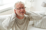 senior man suffering from neckache at home