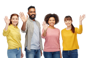 international group of happy people waving hands