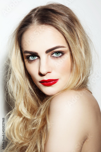 Portrait of young beautiful girl with long messy hair and red lips